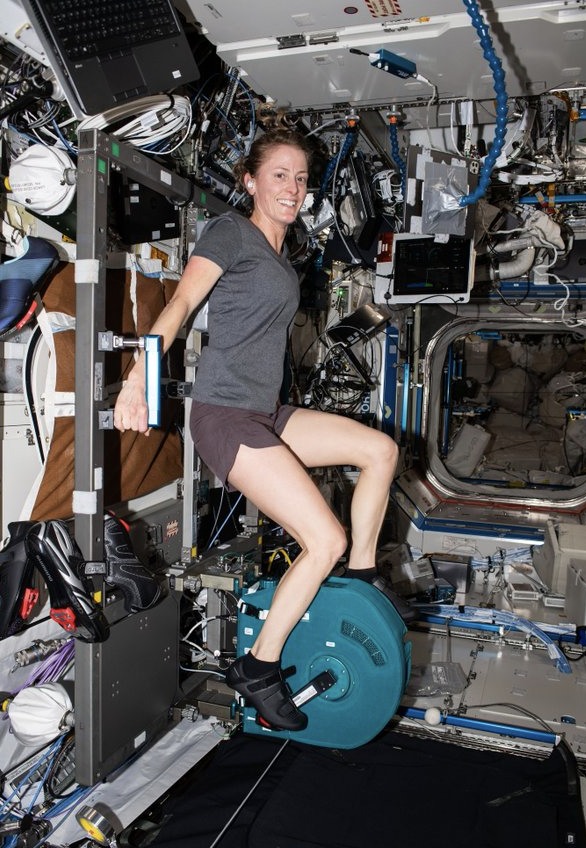 Astronaut Loral O’Hara exercises on the new teal CEVIS Ergometer on board ISS.