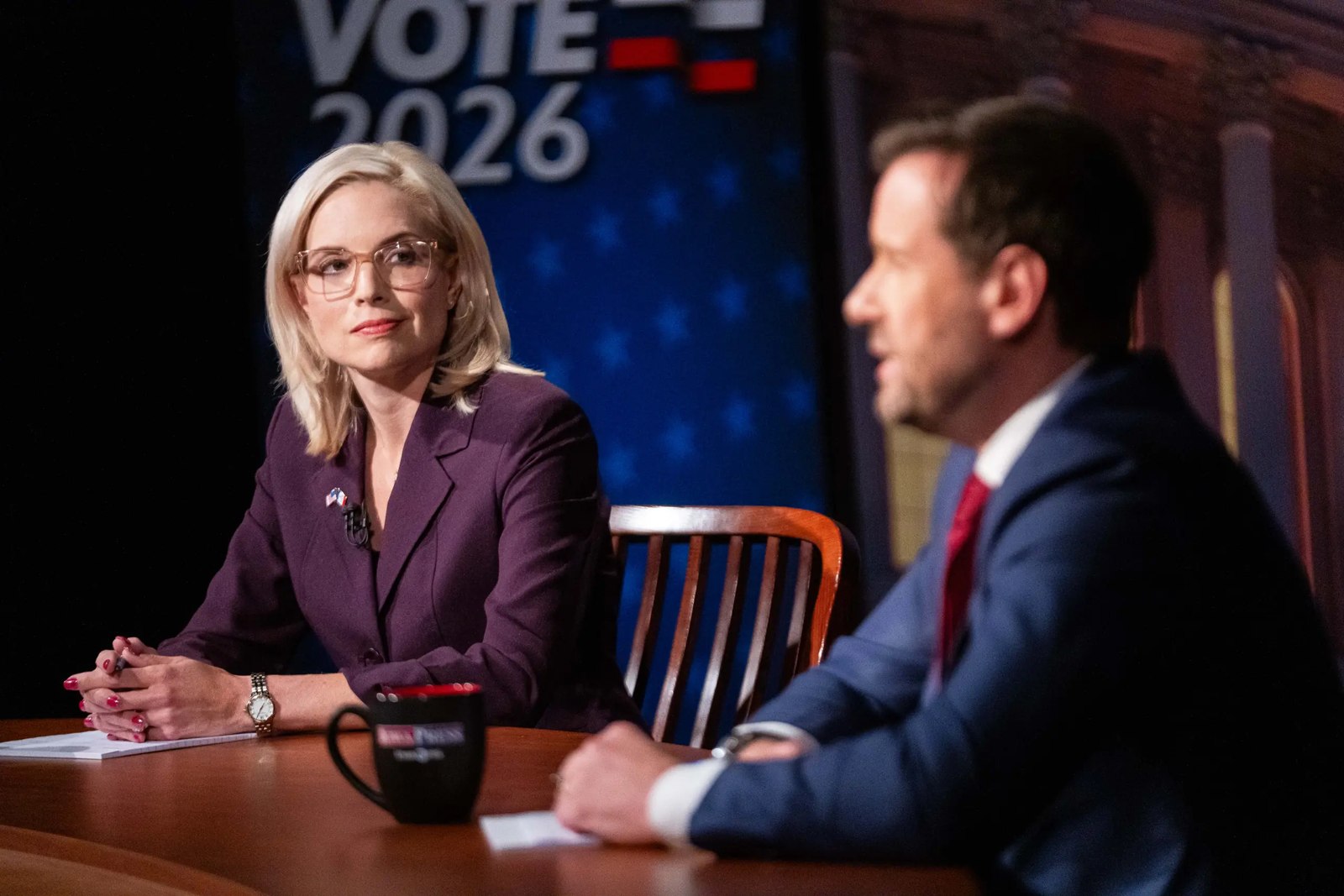 Hinson listens as Josh Turek speaks during their Johnston debate, October 7, 2026.